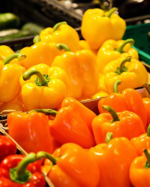 Colourful mix of different red, orange, yellow fresh bell pepper at market.