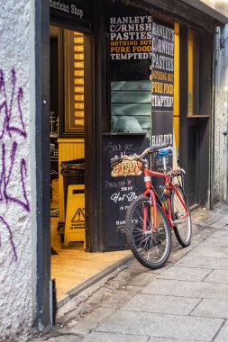 Sabahın erken saatlerinde tapınak barının duvarına yaslanan kırmızı bisiklet, İrlandalı ünlü barlar, kentsel ve sokak fotoğrafçılığı, 17 / 01 / 2022, Dublin, İrlanda