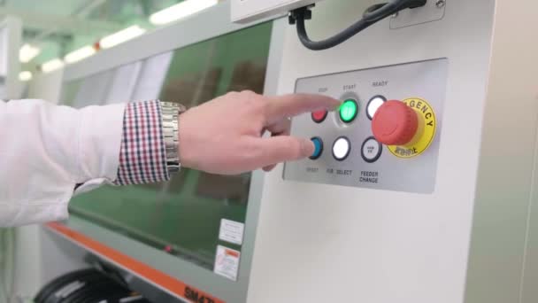 Hand presses the start button on industrial equipment. The engineer starts the production line. Control panel on the machine. — Stock Video