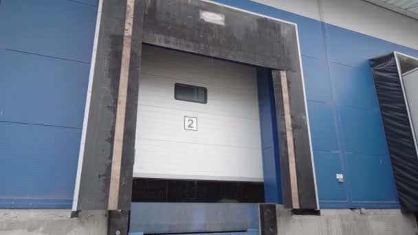 Opening the warehouse door. Large roll-up gates to the enterprise shooting from the street. Roller shutter door of the hangar. — Stock Video