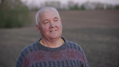 Gün batımına bakan yaşlı bir adamın portresi. Yaşlı bir köylünün buruşuk suratı. Mutlu tutku kavramı. Düşünceli büyükbaba..