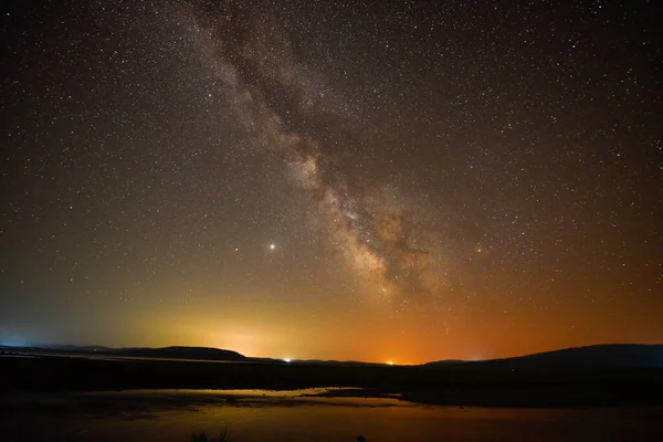 A breathtaking view of the Milky Way at night in Arpi lake, Armenia
