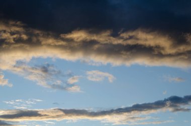 Mavi gökyüzünde koyu ağır bulutlar. Yaz, güneş.