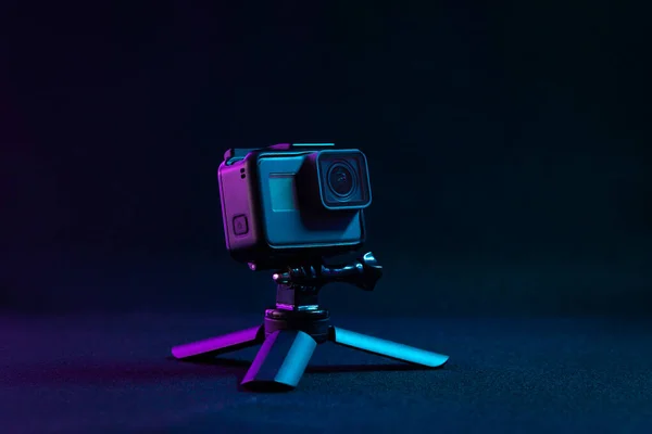 action camera on a tripod. Colorful studio lighting