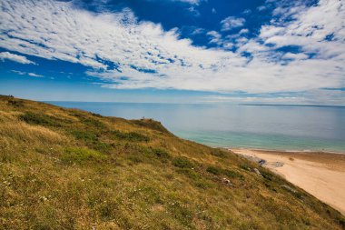 Bulutlu gökyüzü ve doymuş renklerle sahnenin manzarası. Altın saat kum tepeciği, çimen okyanus manzarası. Cotentin Carteret Manche Fransa 'da güzel bir sahil..