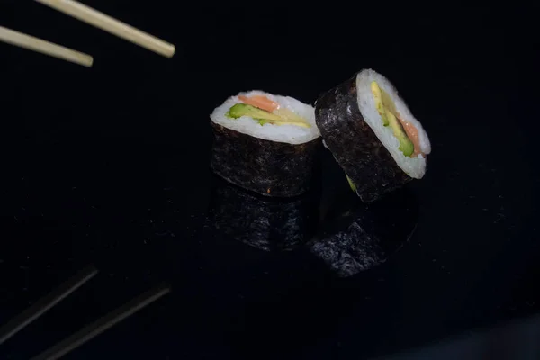 Two Pieces Sushi Chopsticks Dark Background High Quality Photo — Stock Photo, Image