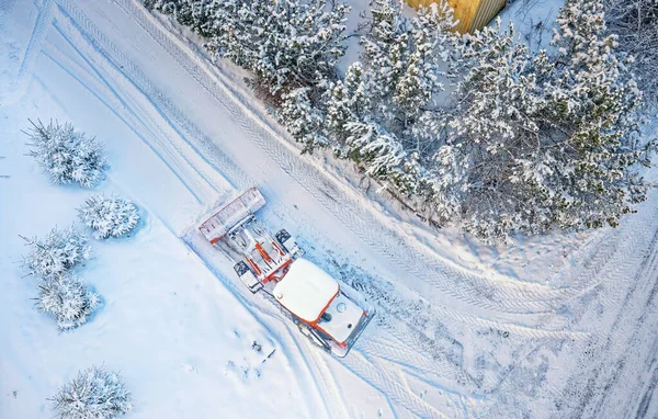 Snow removing with red tractor on the road. Suny winter day, Drone top view. — Zdjęcie stockowe