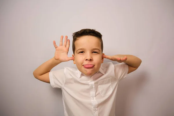 European Boy Shows Emotions Shows His Tongue Five Fingers White — Stock Photo, Image