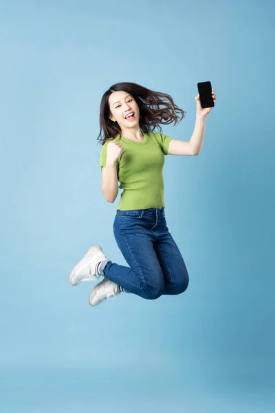 Portrait Beautiful Young Asian Girl Jumping Isolated Blue Background — Stock Photo, Image