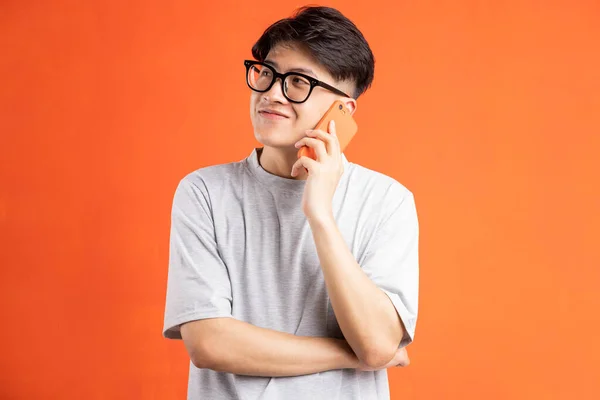 Portrait Young Asian Man Phone Isolated Orange Background — Stock Photo, Image