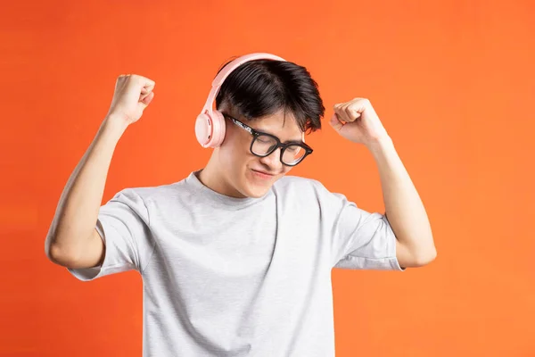 Portrait Young Asian Man Wearing Headphones Dancing Isolated Orange Background — Stockfoto