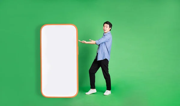 Full Body Image Asian Man Standing Next Big Smartphone Isolated — Stock Photo, Image