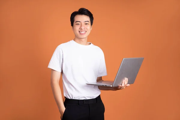 Asian Man Holding Laptop Isolated Orange Background — Stock Photo, Image