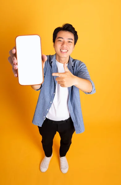 Image Asian Man Holding Phone Isolated Yellow Background — Stock Photo, Image