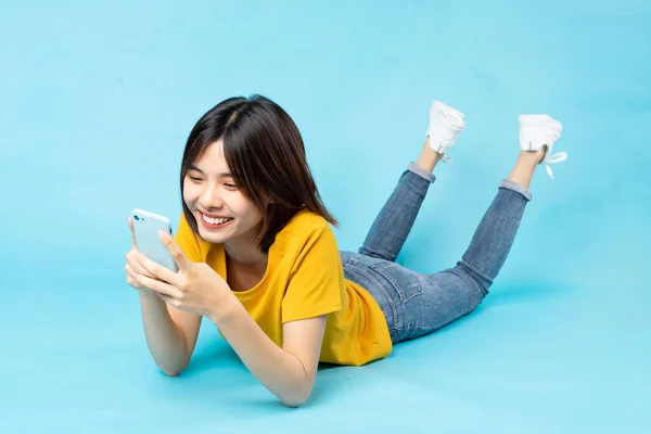 Full Body Portrait Playful Asian Girl Lying Blue Background — Stock Photo, Image
