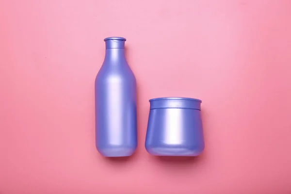 bottle of shampoo with hair mask on a pink background. Minimalism, place for text. Top view