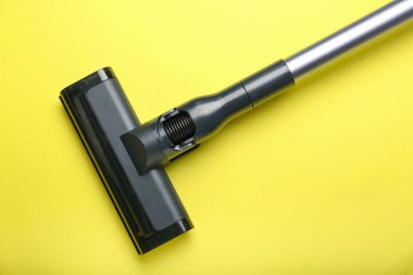 vacuum cleaner on yellow background. View from above
