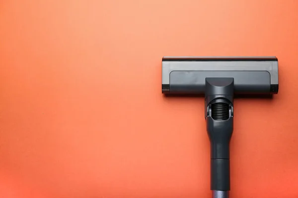 vacuum cleaner on orange background. top view