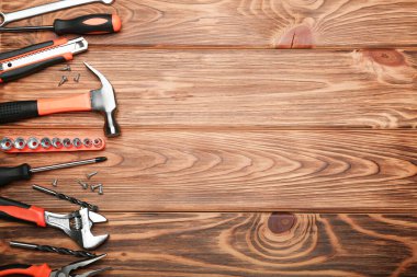 Set of various construction tools on a wooden background. Tools for home repair. Work at a construction site. Top view. Space for text