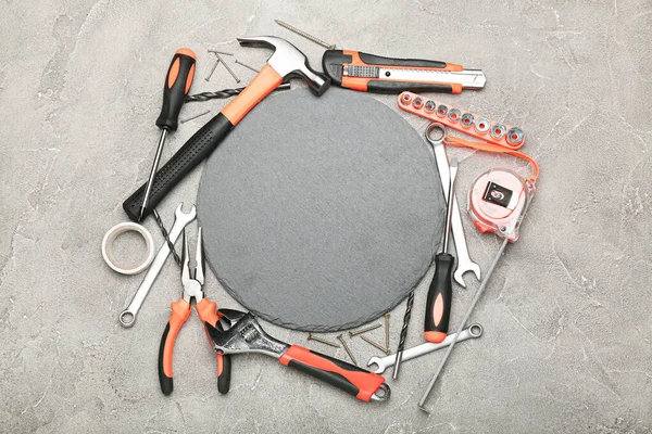 Set of various construction tools around a circle on a gray background. Tools for home repair. Work at a construction site. top view.
