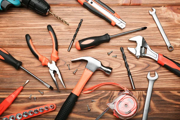 Set of various construction tools on a wooden background. Tools for home repair. Work at a construction site. Top view