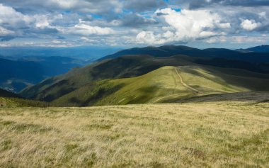 Stormy clouds over high altitude pastures of Capatanii Mountains, Carpathians, Romania. Spring Season