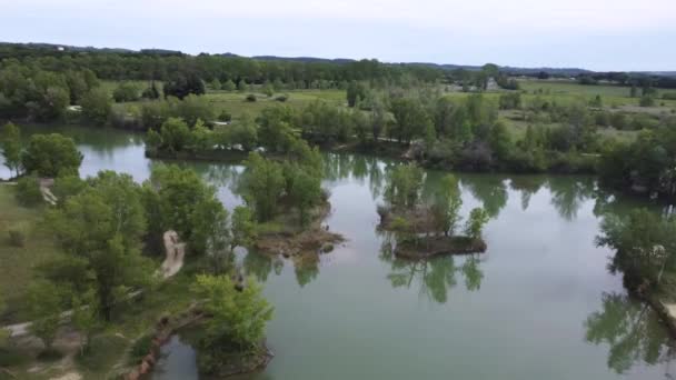 Beautiful landscape in aerial drone shot. Forest woods and a calm tranquil lake — Stockvideo