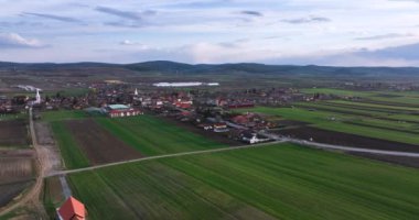 Drone footage of the green land and small city in the mountain. high-quality 5.1k DJI Mavic 3 4k footage shoot in May 2022 in South Romania