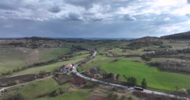 Aerial view of cars and trucks on a country road. Green field among agriculture. high-quality 5.1k DJI Mavic 3 4k footage shoot in May 2022 in South Romania