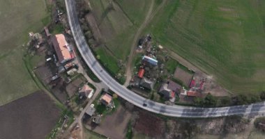 Aerial top-down cinematic summer country road Cars driving along the curved road. high-quality 5.1k DJI Mavic 3 4k footage shoot in May 2022 in South Romania