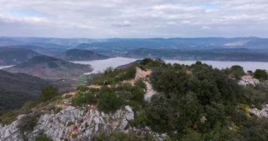 Aerial panorama of Lac du Slagou in the early morning in a windy spring. High-quality DJI Mavic 3 5.1k and 4k footage were made in January 2022 in Lac du Salagou South of France on a cloudy cold day.