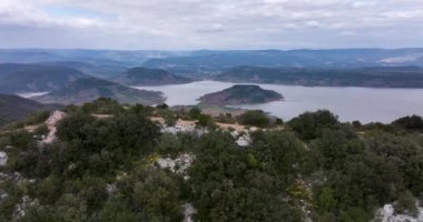 Aerial panorama of Lac du Slagou in the early morning in a windy spring. High-quality DJI Mavic 3 5.1k and 4k footage were made in January 2022 in Lac du Salagou South of France on a cloudy cold day.