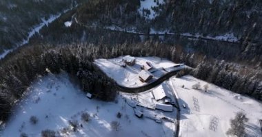 Aerial view over the individual houses private small town residential covered in snow. High-quality DJI Mavic 3 5.1k and 4k footage in January 2022 in Borsa, Romania a town in eastern Maramures County