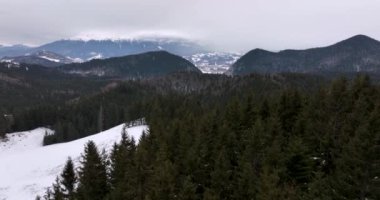 From great heigh fairytale mountain landscape snow covered mountain and peaks. High-quality DJI Mavic 3 5.1k and 4k footage made in Romania in February 2022. Beautiful winter hike. Snowy forest.
