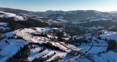 Snow-covered mountain peak, cinematic view, forestand mountain background. High-quality DJI Mavic 3 5.1k and 4k footage in January 2022 in Borsa, Romania a town in eastern Maramures County