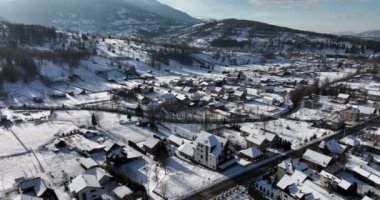  Aerial view of a famous Romania ski resort town in winter. Buildings and houses. High-quality DJI Mavic 3 5.1k and 4k footage shot in January 2022 in Borsa, Romania a town in eastern Maramures County