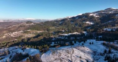 Aerial top down cinematic winter snow-covered country road, asphalt road. High-quality DJI Mavic 3 5.1k and 4k footage in January 2022 in Borsa, Romania a town in eastern Maramures County