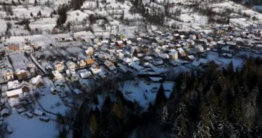 Aerial birds eye view of a small Romanian village with a snow-covered roof in winter. High-quality DJI Mavic 3 5.1k and 4k footage in January 2022 in Borsa, Romania a town in eastern Maramures County