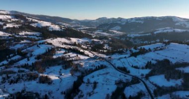 Snow-covered mountain peak, cinematic view, forestand mountain background. High-quality DJI Mavic 3 5.1k and 4k footage in January 2022 in Borsa, Romania a town in eastern Maramures County
