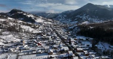 Middle-class suburban houses and streets under heavy snow. Aerial view of a city. High-quality DJI Mavic 3 5.1k and 4k footage shot in January 2022 in Borsa, Romania a town in eastern Maramures County
