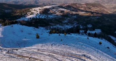 Snow-covered mountain peak, cinematic view, forestand mountain background. High-quality DJI Mavic 3 5.1k and 4k footage in January 2022 in Borsa, Romania a town in eastern Maramures County