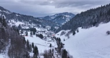 Aerial circling epic winter snow-covered valley in Hunedoara. Abstract nature. High-quality DJI Mavic 3 5.1k and 4k footage shot in January 2022 in Borsa, Romania a town in eastern Maramures County