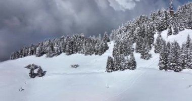 Beautiful epic scale mountain range Romanian Mountains drone footage clouds. High-quality DJI Mavic 3 5.1k and 4k footage made in Romania in February 2022. Beautiful winter hike. Snowy mountain.