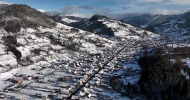 Middle-class suburban houses and streets under heavy snow. Aerial view of a city. High-quality DJI Mavic 3 5.1k and 4k footage shot in January 2022 in Borsa, Romania a town in eastern Maramures County