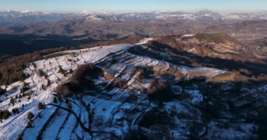Snow-covered mountain peak, cinematic view, forestand mountain background. High-quality DJI Mavic 3 5.1k and 4k footage in January 2022 in Borsa, Romania a town in eastern Maramures County