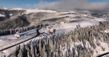 The monastery Pirslop and the Pass In Maramuses are Covered in the snow on a sunny day.High-quality DJI Mavic 3 5.1k and 4k footage in January 2022 in Borsa, Romania a town in eastern Maramures County