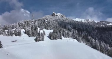 Epic aerial over cinematic mountains peaks on a sunny snowy winter day. High-quality DJI Mavic 3 5.1k and 4k footage made in Romania in February 2022. Beautiful winter hike. Snowy mountain.