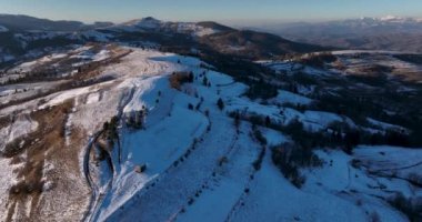 Snow-covered mountain peak, cinematic view, forestand mountain background. High-quality DJI Mavic 3 5.1k and 4k footage in January 2022 in Borsa, Romania a town in eastern Maramures County