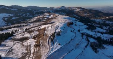 Fly over Majestic mountain peaks sunny day Romanian Mountains Travel destination. High-quality DJI Mavic 3 5.1k and 4k footage in January 2022 in Borsa, Romania a town in eastern Maramures County