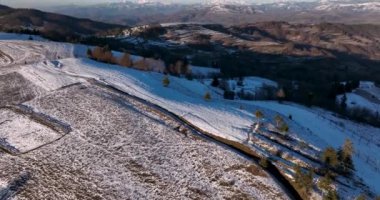 Fly over Majestic mountain peaks sunny day Romanian Mountains Travel destination. High-quality DJI Mavic 3 5.1k and 4k footage in January 2022 in Borsa, Romania a town in eastern Maramures County